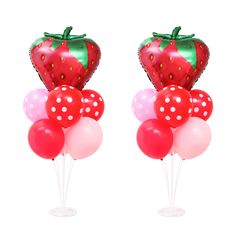 two strawberry shaped balloons are on top of each other with polka dots and one has a green leaf