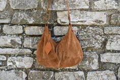 a brown bag hanging on a brick wall