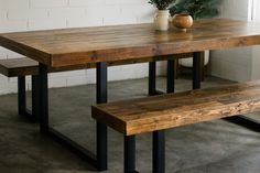 a wooden table with two benches next to it and a potted plant on top