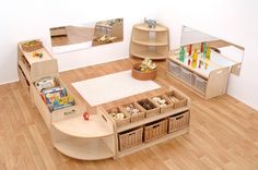 a child's playroom with toys and books on the floor, including shelves