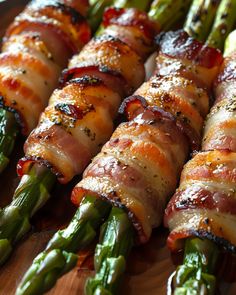 asparagus wrapped in bacon on a wooden platter