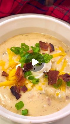 a bowl of soup with bacon, cheese and green onions