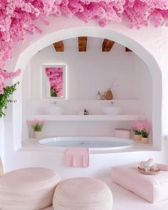 a white bathroom with pink flowers on the ceiling and bathtub in the middle,