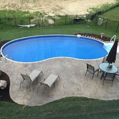 an above ground swimming pool surrounded by lawn furniture