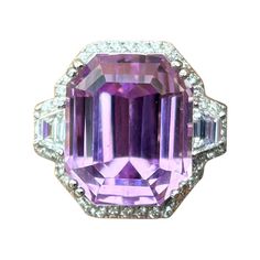 A stunning purple-pink 14.27 carat emerald cut Kunzite center stone, with 0.37 carat trapeze shaped White Diamond side stones, VS quality G/H color, and 0.32 carat round White Diamonds surrounding it. The Kunzite is of top quality, ideal intense color, without any inclusions, and great luster, making it the perfect stone to be set in a ring! The ring is made using 18K White Gold, currently sized at US7, can be resized. We provide free shipping, and accept returns. Please message us for more information! 5 Carat Ring, Split Shank Ring, Diamond Cocktail Rings, Three Stone Engagement, Modern Ring, Three Stone Engagement Rings, Pretty Wedding, Three Stone Rings, Gem Stone