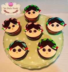 six cupcakes are sitting on a green plate