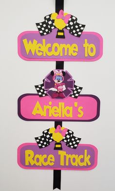 a sign that says welcome to ariella's race track and is hanging on the wall