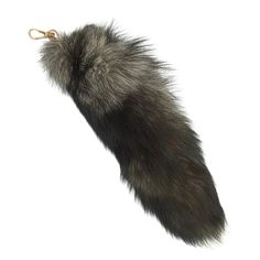 an animal tail is hanging from a keychain