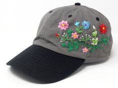 a baseball cap with embroidered flowers on it