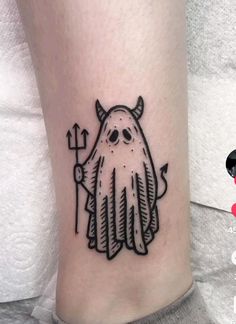 a black and white image of a ghost with an arrow tattoo on the ankle area