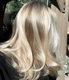 the back of a woman's head with blonde hair