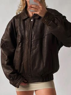 Embrace the spirit of the '90s with this oversized vintage dark brown genuine leather bomber jacket. Made from luxurious leather, this piece boasts a soft, supple feel that elevates any outfit. The oversized silhouette offers a relaxed, laid-back vibe, making it perfect for layering over your favorite tees or sweaters. With its classic bomber design, this jacket combines comfort and style effortlessly. The rich dark brown hue adds a touch of sophistication, while the subtle sheen from the waxed finish gives it a unique character. Functional pockets provide practicality without sacrificing style, making it a versatile staple for any wardrobe. Whether you're heading out for a casual day or dressing up for a night on the town, this vintage bomber jacket is the perfect blend of nostalgia and c Chic Outerwear, Womens Biker Jacket, Womens Jackets Casual, Straight Jacket, Casual Wear Women, Real Leather Jacket, Lady Biker, Genuine Leather Jackets, Brown Leather Jacket