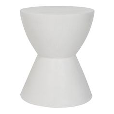 a white vase sitting on top of a table