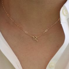 "14K Toggle Necklace, Gold Paper Clip Chain, Delicate Necklace Gold Choker. 14K gold Long Link Chain This necklace can be worn by itself or with other necklaces. *The chain, toggle clasp and all components are 14K solid yellow gold (If you order a 16\" necklace, it will be a toggle clasp plus chain will be 16\".) *The toggle clasp is about 3/8\" The model in the picture wears a 16\" necklace. Please read our policies before you place your order. https://www.etsy.com/shop/SashJewelry/policy?ref=s Elegant Round Toggle Necklace With Cable Chain, Classic 14k Gold Lariat Necklace, Timeless Yellow Gold Toggle Necklace With Adjustable Chain, Classic Yellow Gold Oval Link Toggle Necklace, Timeless Yellow Gold Necklace With Toggle Clasp, Elegant Toggle Necklace With Cable Chain Link, Elegant Yellow Gold Toggle Necklace With Cable Chain, Classic Yellow Gold Toggle Necklace For Formal Events, Timeless Yellow Gold Toggle Necklace