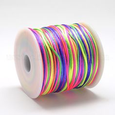 a spool of neon colored thread on a white background