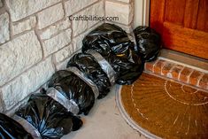 black trash bags are lined up on the front porch to be used as an entrance mat