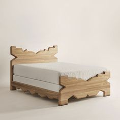 a bed made out of wood and white sheets