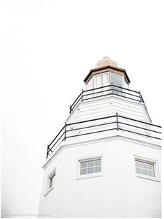 a tall white building with a clock on it's side