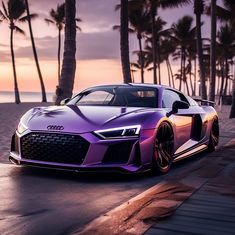 a purple car parked on the side of a road next to palm trees and water