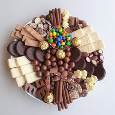 a platter filled with lots of different types of candy and candies on top of each other