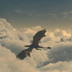 a dragon flying through the sky above some clouds