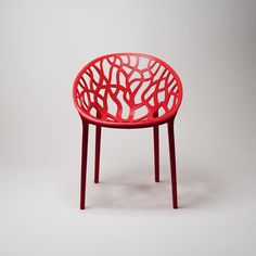 a red chair sitting on top of a white floor