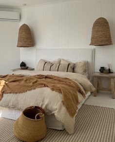 a large bed sitting next to two baskets on the floor