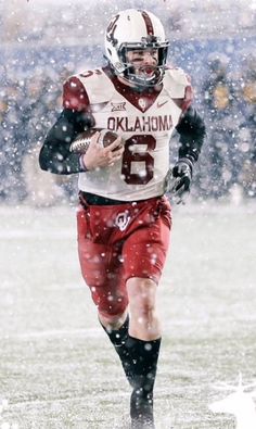 a football player is running in the snow