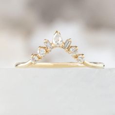 a yellow gold ring with three diamonds on it