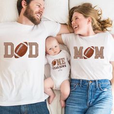 Football First Birthday Family Matching Shirts  Football 1st Birthday Tshirt, Football Theme Birthday Outfit, 1st Year Down Shirt Toddler Birthday HOW TO ORDER: 1- Please check all of the photos. 2- Select your T-shirt size from selection box. 3- Select your T-shirt color from the selection box. 4- Personalization box is only for design color information, enter your design or text color in the personalization box (see images for options). 5- Select the quantity. 6- Go to add to cart. 7- Complete Football Birthday Outfit, First Year Down Football Birthday Outfit, White T-shirt For Father's Day Family Events, Personalized White T-shirt For Father's Day, Family Matching Custom Print T-shirt For First Birthday, Family Matching Letter Print T-shirt For First Birthday, Family Matching T-shirt For First Birthday, Customizable Family Matching T-shirt For First Birthday, Family Matching T-shirt With Name Print For First Birthday