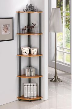 a corner shelf with three shelves in the middle and two lamps on either side of it