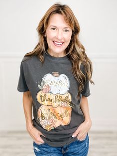 a smiling woman wearing a black thanksgiving t - shirt