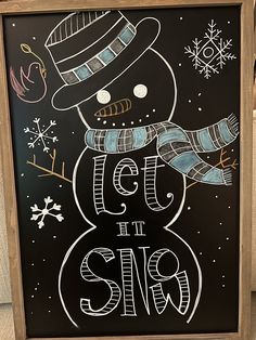 a chalk board with a snowman drawn on it