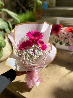 a person holding a bouquet of flowers in their hand