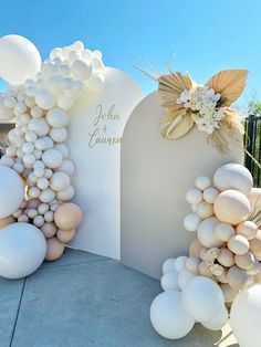 balloons and flowers decorate the entrance to an event