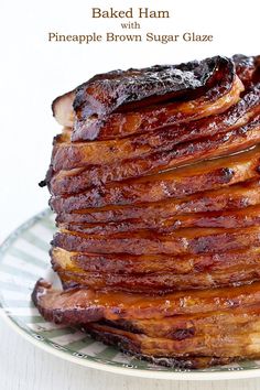 a stack of cooked bacon on a plate with the words baked ham with pineapple brown sugar glaze