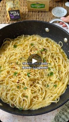 a pan filled with pasta and sauce on top of a table