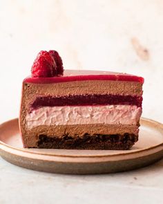 a piece of chocolate cake with raspberries on top