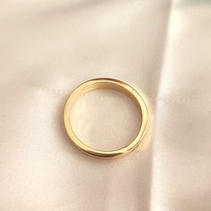 a gold ring sitting on top of a white cloth