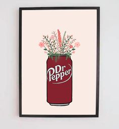 a red can with flowers in it is hanging on the wall