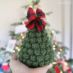 a small crocheted christmas tree with a red bow