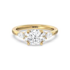 a yellow gold engagement ring with three stones