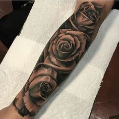 a black and grey rose tattoo on the arm by dohn tattu in san francisco, california