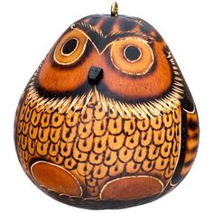 an owl shaped ornament is shown against a white background and has orange, brown, and black designs on it