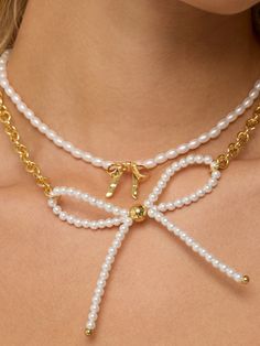 Add a charming touch to your outfit with our Encouraged Mini Bow Necklace! This dainty accessory features a mini bow and pearl, perfect for layering or wearing on its own. Cute and versatile, it's a must-have addition to any jewelry collection. Imitation Pearl Beads 40cm + 9 long 18k Gold Plated Over Brass 18K Gold Center Mini Bow Extendable Lobster Clasp Bow Necklace, Bow Jewelry, Mini Bows, Beaded Bags, Fringe Earrings, Brass Earrings, Seed Bead Earrings, Pearl Beads, Pretty In Pink