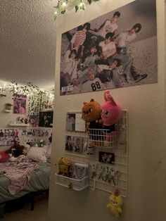 there is a bedroom with pictures on the wall and stuffed animals hanging from the ceiling