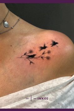 a woman's back shoulder with black ink flowers on the left side of her neck