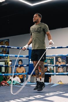 a man standing on top of a boxing ring while holding a white object in his hand