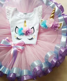 a pink and blue tutu skirt with a unicorn t - shirt in the center