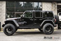 a black jeep parked in front of a building